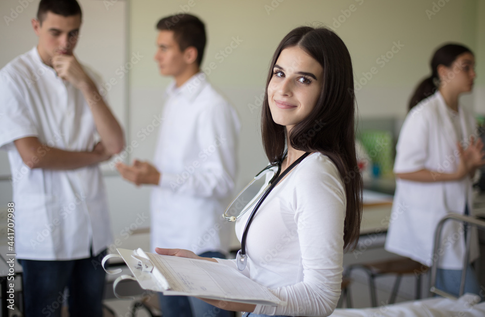 Time for checking a patient. Medical students in patient room. Focus is on foreground. Time for checking a patient. Medical students in patient room. Focus is on foreground.