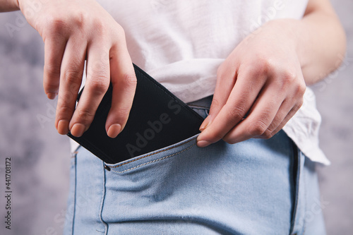 woman puts her wallet in her pocket