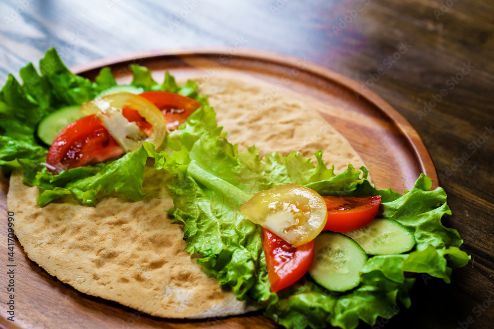 pita with vegetables. simple and delicious snack of flatbread pita with vegetables. simple and delicious snack of flatbread