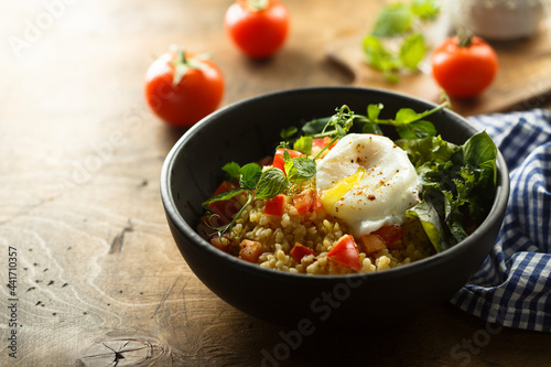 Bulgur with tomato and poached egg