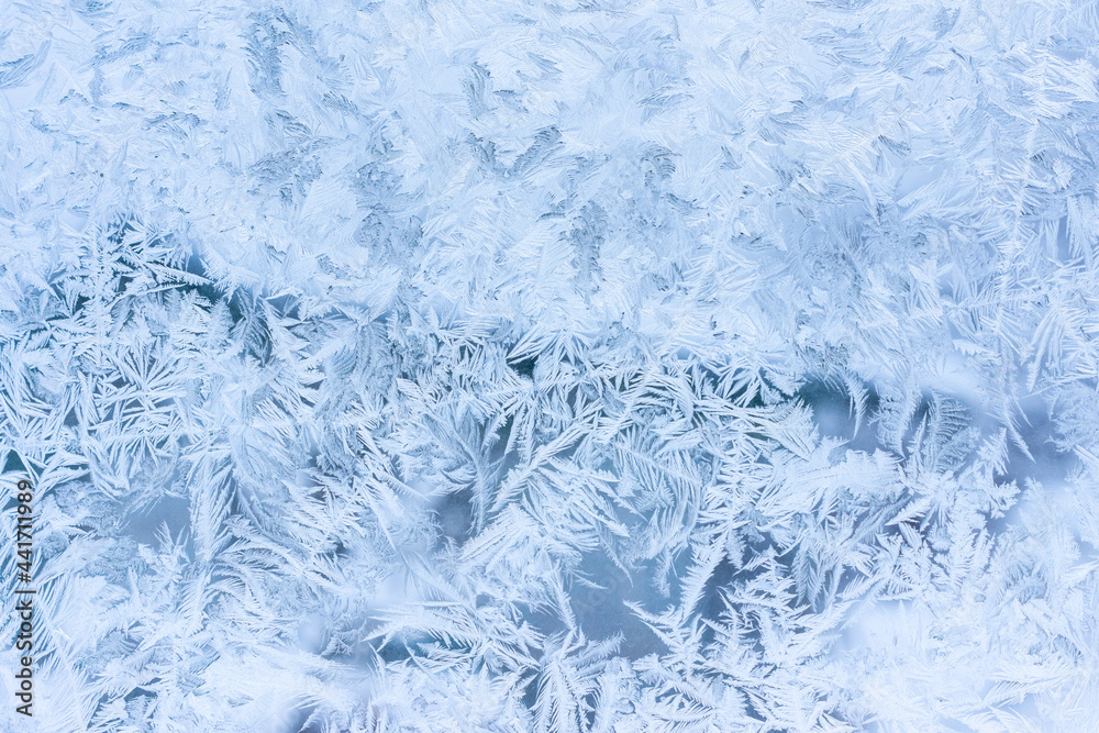 Frosty patterns on a winter window. Cold weather, Christmas mood Frosty patterns on a winter window. Cold weather, Christmas mood