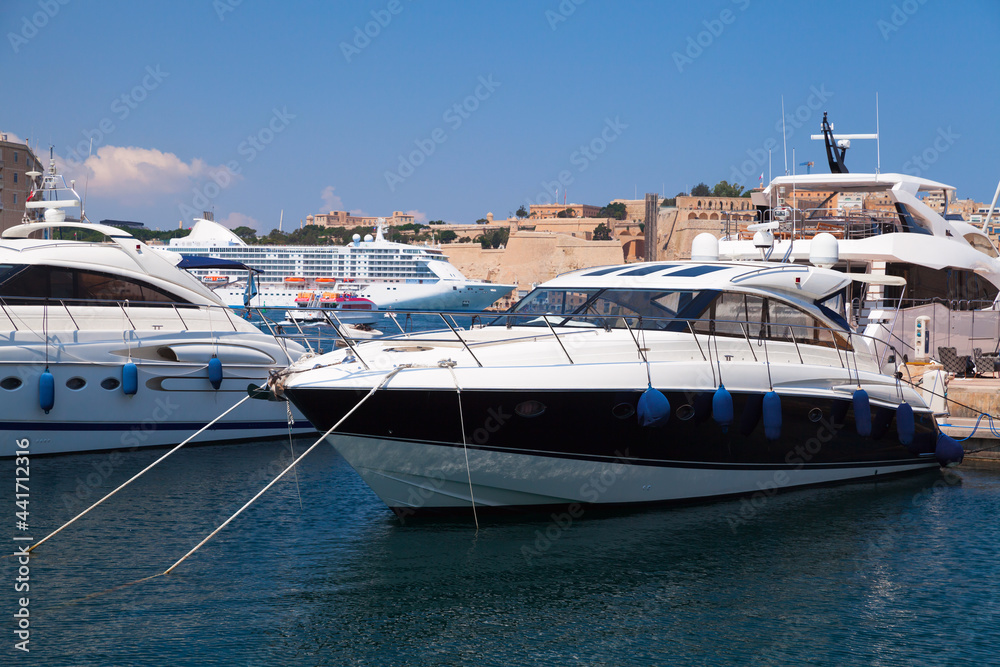 Fototapeta premium Motor yachts moored in marina on a sunny day. Valletta, Malta