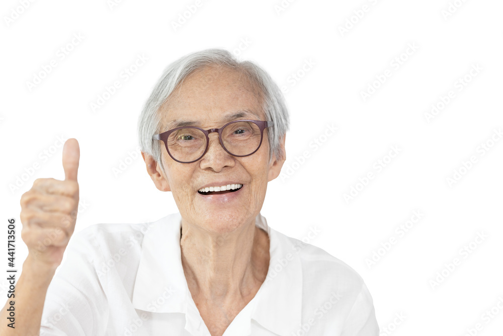 Happy asian old elderly wearing spectacles,raising hand sign,showing great thumbs up,smiling senior woman giving a thumbs up gesture,symbol of likes,good or success,isolated on white background Happy asian old elderly wearing spectacles,raising hand sign,showing great thumbs up,smiling senior woman giving a thumbs up gesture,symbol of likes,good or success,isolated on white background