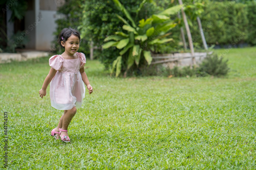 Adorable Little Thai girl running at field Adorable Little Thai girl running at field