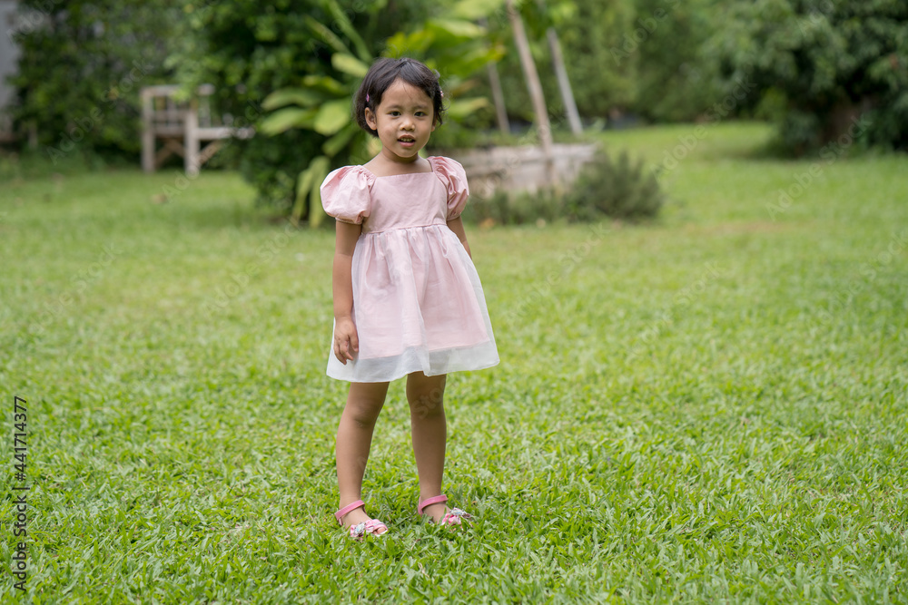 smiling Asian girl standing at field. smiling Asian girl standing at field.