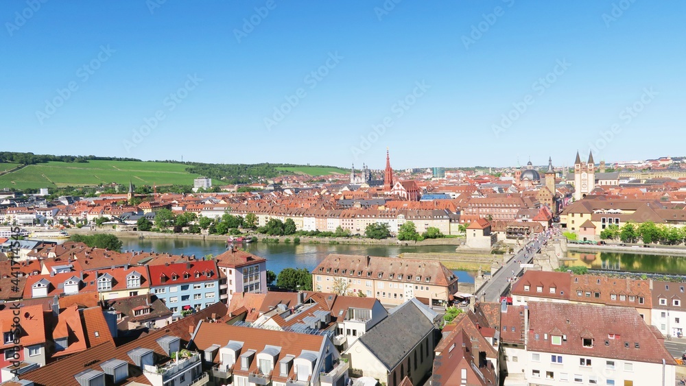The picturesque panorama view of both banks of Wurzburg city along River Main. All houses were built with red roof.