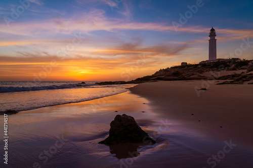 Atardecer en la playa del faro de Trafalgar en Caños de Meca, Provincia de Cádiz, Andalucía, España photo