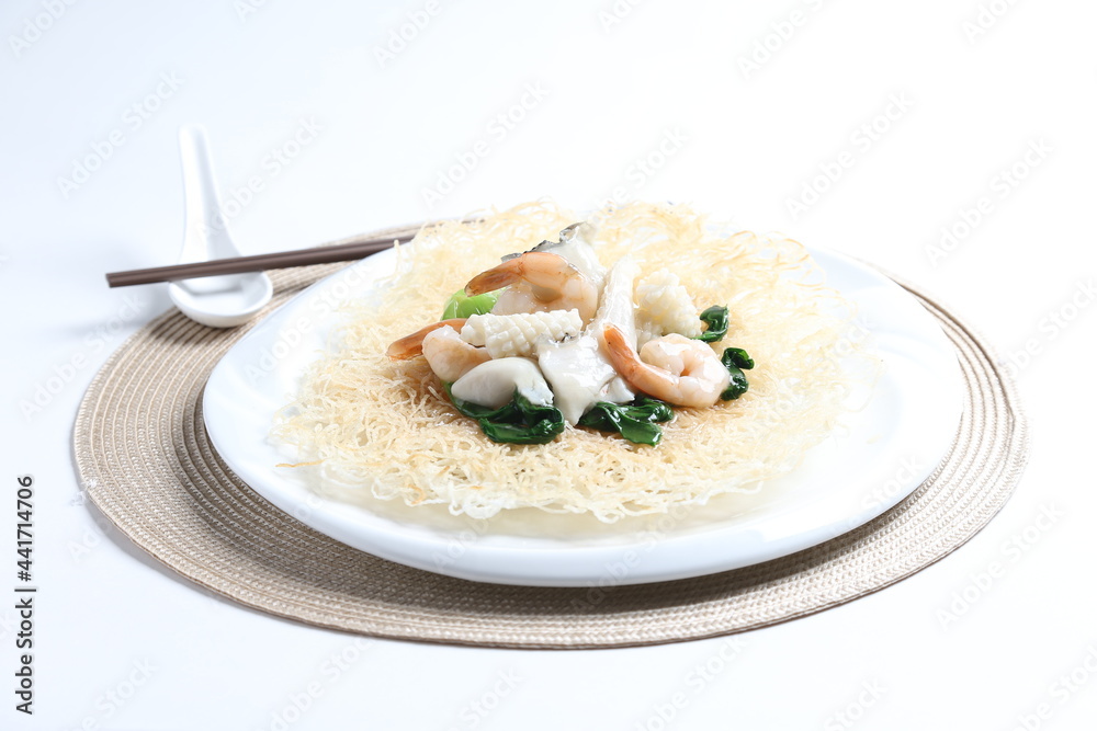 deep fried crispy bee hoon noodle with mixed seafood fish, prawn, squid, octopus and vegetables in thick egg gravy sauce asian halal menu deep fried crispy bee hoon noodle with mixed seafood fish, prawn, squid, octopus and vegetables in thick egg gravy sauce asian halal menu