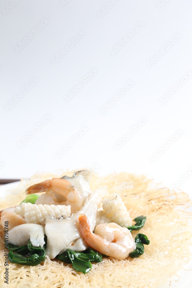 deep fried crispy bee hoon noodle with mixed seafood fish, prawn, squid, octopus and vegetables in thick egg gravy sauce asian halal menu deep fried crispy bee hoon noodle with mixed seafood fish, prawn, squid, octopus and vegetables in thick egg gravy sauce asian halal menu