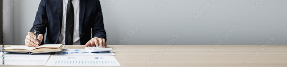 Businessman sits in a private office at his company and is reviewing company financial documents, senior management checking financial information for accuracy. Financial management. copy space Businessman sits in a private office at his company and is reviewing company financial documents, senior management checking financial information for accuracy. Financial management. copy space