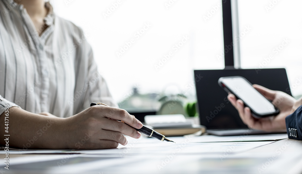Two businessmen are brainstorming together and reviewing the company financial documents that the finance department has summarized, they are business partners. Business administration concept. Two businessmen are brainstorming together and reviewing the company financial documents that the finance department has summarized, they are business partners. Business administration concept.