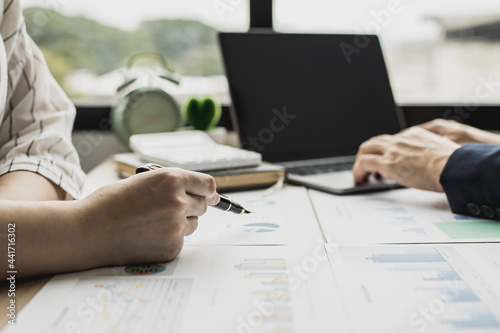 Two businessmen are brainstorming together and reviewing the company financial documents that the finance department has summarized, they are business partners. Business administration concept. photo