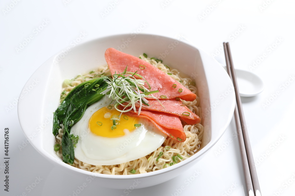 chef cook noodle mee soup with chicken ham and fried egg and vegetable asian halal menu
