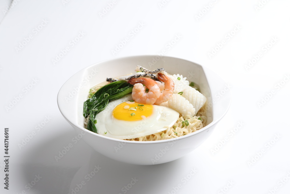 chef cook noodle mee soup with mixed seafood prawn, squid , fish, fried egg and vegetable asian halal menu chef cook noodle mee soup with mixed seafood prawn, squid , fish, fried egg and vegetable asian halal menu