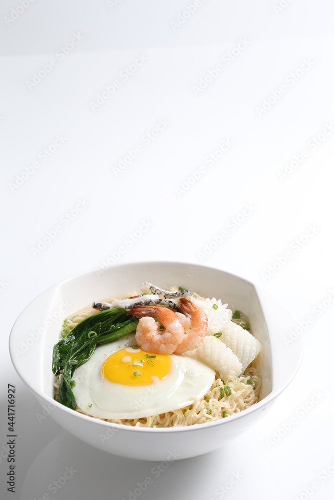 chef cook noodle mee soup with mixed seafood prawn, squid , fish, fried egg and vegetable asian halal menu chef cook noodle mee soup with mixed seafood prawn, squid , fish, fried egg and vegetable asian halal menu