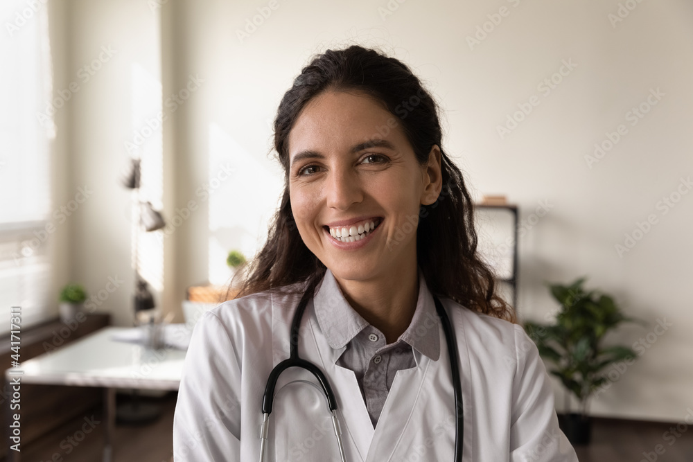 Headshot close up portrait of smiling young Caucasian female doctor in medical white uniform in clinic. Profile picture of happy confident successful woman nurse GP in hospital. Healthcare concept. Headshot close up portrait of smiling young Caucasian female doctor in medical white uniform in clinic. Profile picture of happy confident successful woman nurse GP in hospital. Healthcare concept.