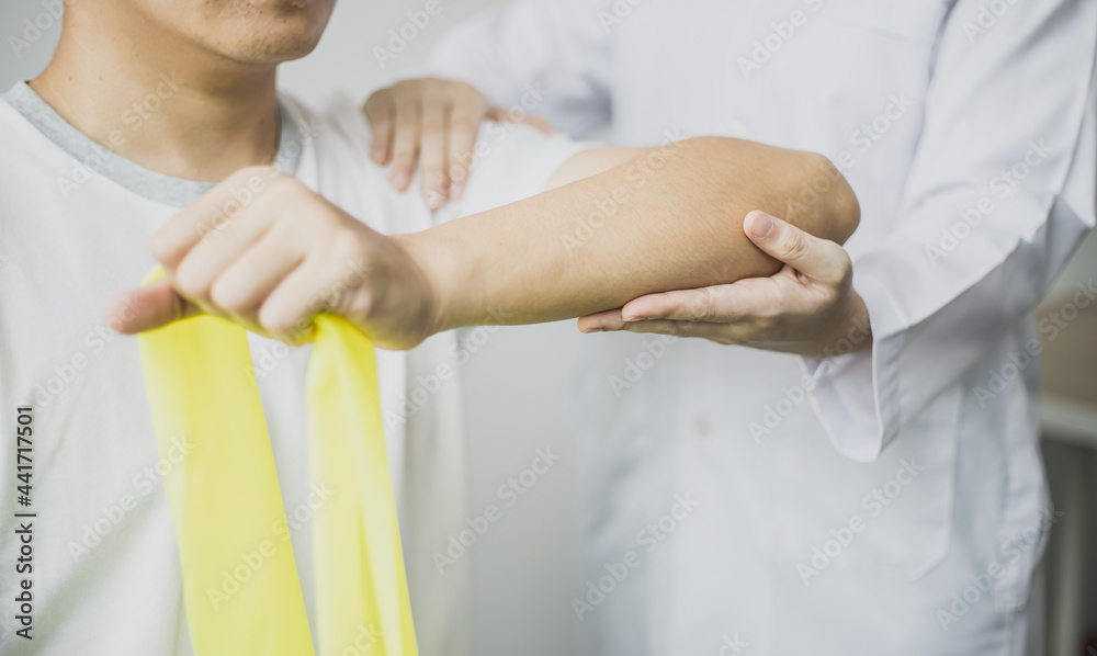 A professional physiotherapist is doing stretching for a patient, the patient has muscle dysfunction due to hard work, most often an office worker who has problems sitting for long periods of time. A professional physiotherapist is doing stretching for a patient, the patient has muscle dysfunction due to hard work, most often an office worker who has problems sitting for long periods of time.