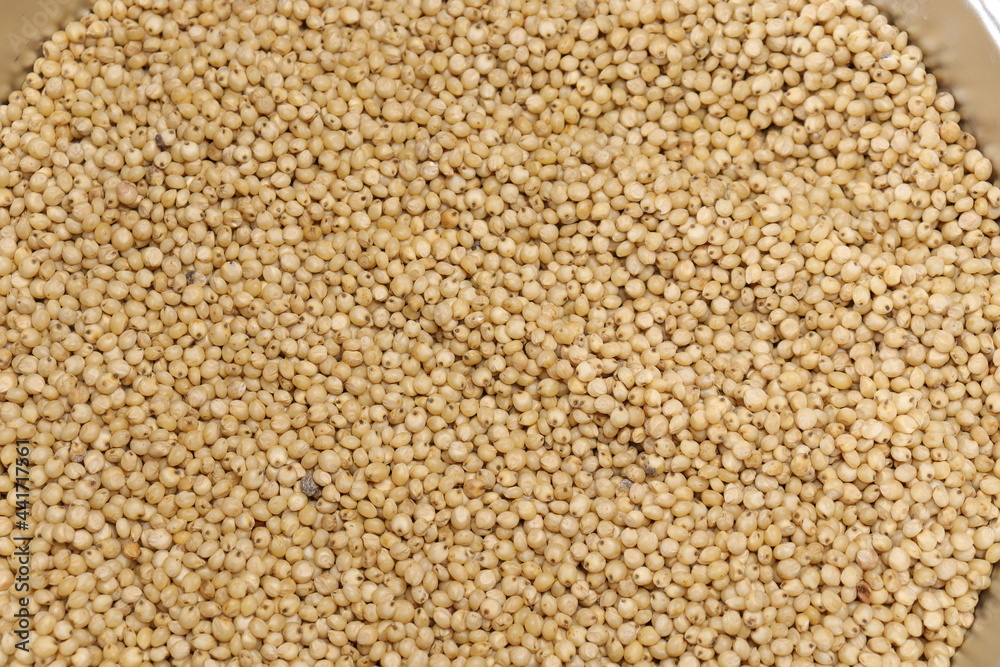 Organic jawar seeds isolated on wood background Organic jawar seeds isolated on wood background
