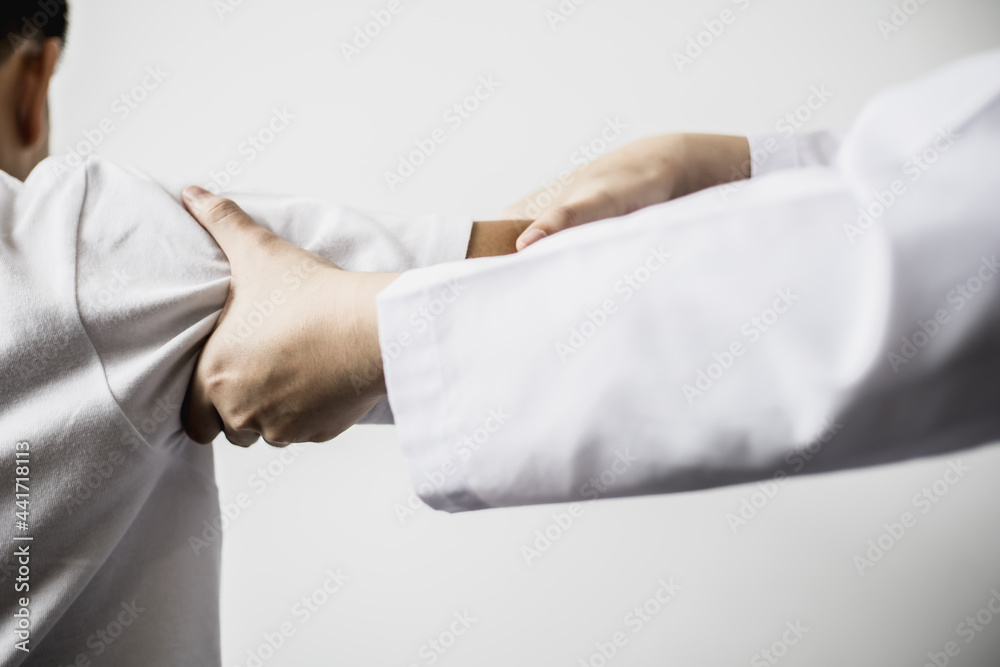A professional physiotherapist is doing stretching for a patient, the patient has muscle dysfunction due to hard work, most often an office worker who has problems sitting for long periods of time. A professional physiotherapist is doing stretching for a patient, the patient has muscle dysfunction due to hard work, most often an office worker who has problems sitting for long periods of time.