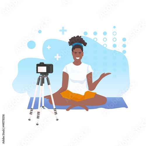 woman fitness trainer recording video blog using camera on tripod live streaming blogging workout concept