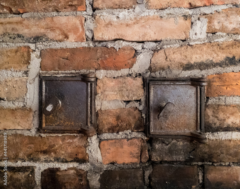 Old brick wall, chimney with metal windows Old brick wall, chimney with metal windows