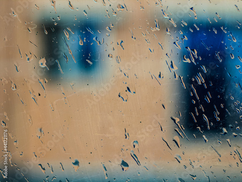 Drops of rain on blue glass background. drops on glass after rain for wallpaper. Drops on glass, window condensation, and the background for dark text.