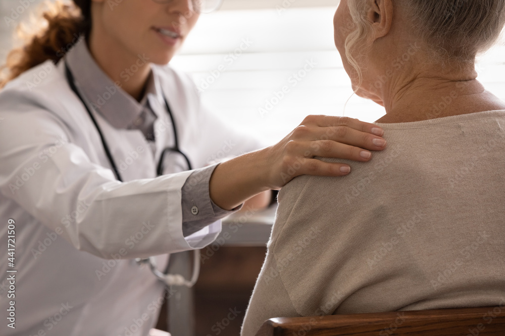 Obraz premium Close up of supportive female nurse or GP touch mature lady patient show care and understanding at clinic consultation. Doctor support comfort old woman client in hospital. Good medicine concept.