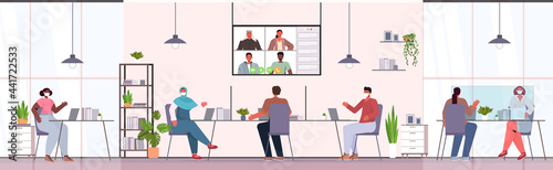 businesspeople in protective masks chatting with colleagues during video call online conference coronavirus pandemic
