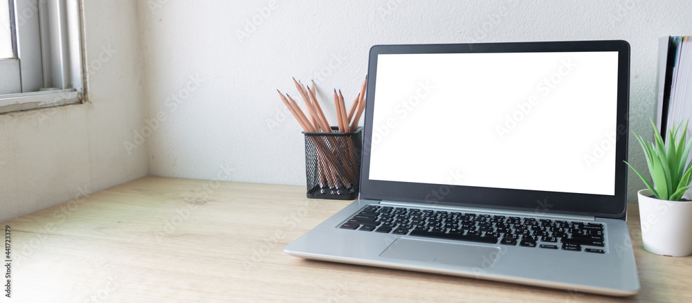 Fototapeta premium Laptop computer with white blank screen on wood desk. Workspace, workplace, desktop office concept.