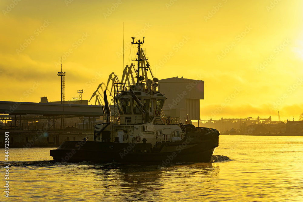 tug boat on sunset in the harbor