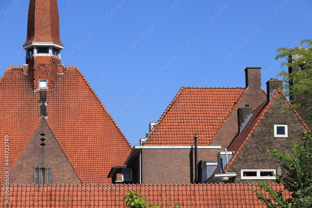 Amsterdam School of Architecture Buildings with Red Roof Tiles and Blue Sky Close Up in Amsterdam, Baarsjes District Amsterdam School of Architecture Buildings with Red Roof Tiles and Blue Sky Close Up in Amsterdam, Baarsjes District