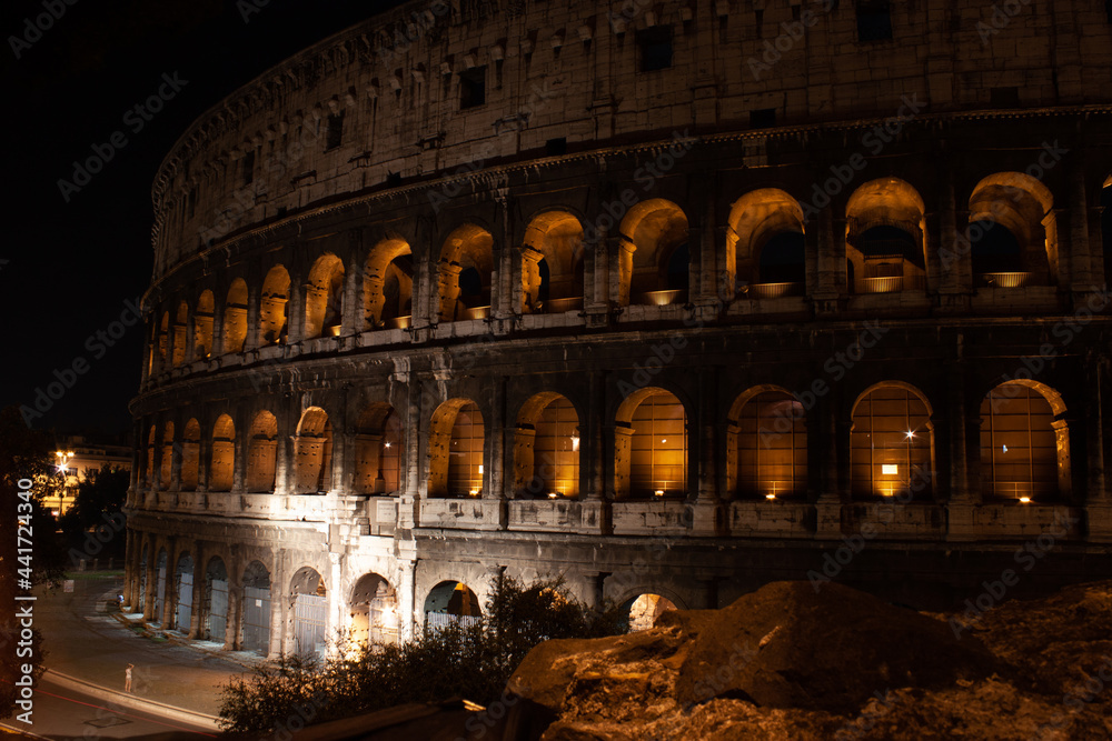 Roman Colosseum under the atmospheric cover of darkness at night in Rome, Italy