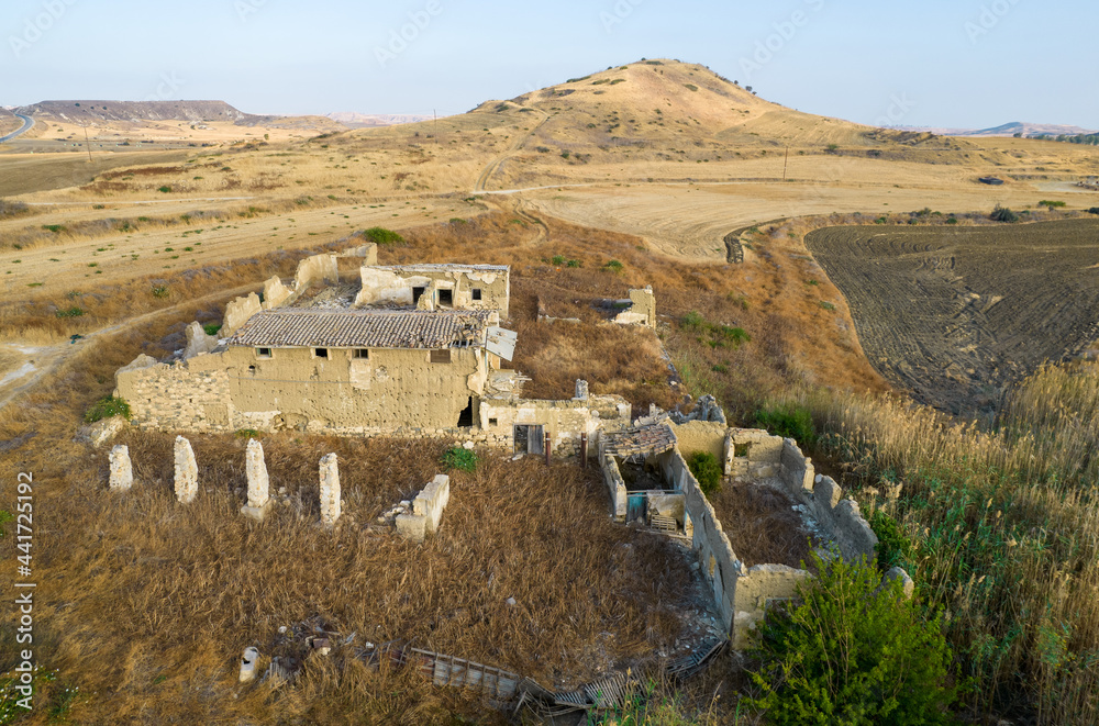 Abandoned and collapsing animal farm building in the field. Deserted places Cyprus