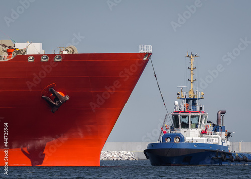 TUGBOAT AND RED TANKER - Ships maneuver in the port
