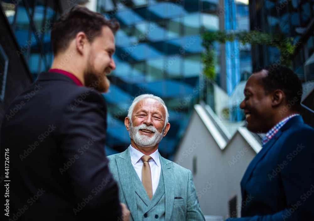 Three business men talking outside. Three business men talking outside.
