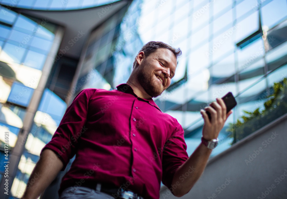 Smiling Business man walking and using mobile. Smiling Business man walking and using mobile.