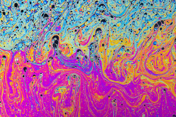 Fluid soap bubble psychedelic colorful abstract art. Surreal patterns with rainbows and waves of color in motion.