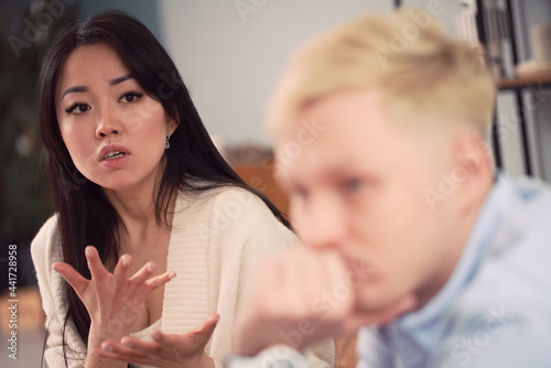 Multiracial couple having argument during psychotherapy session photo