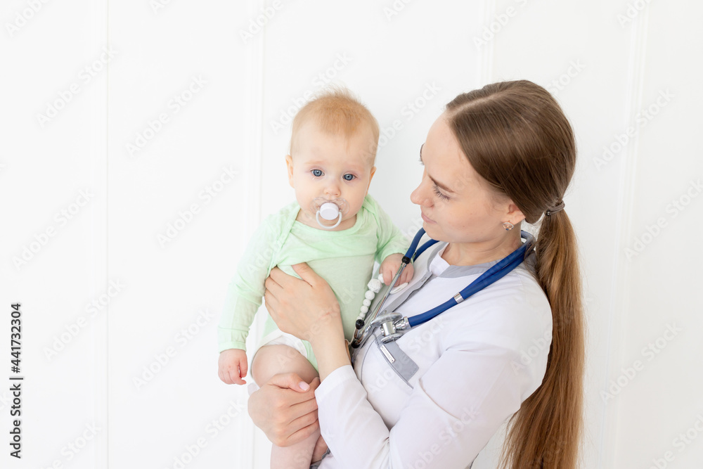 a doctor examines a baby with a stethoscope, a concept of health and medicine a doctor examines a baby with a stethoscope, a concept of health and medicine