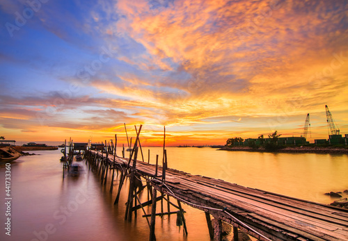 Burning the sky on the wooden pier in the fishing village of batam island