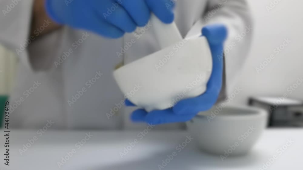 Making an ointment with a mortar in the prescription lab. Initial shot out of focus