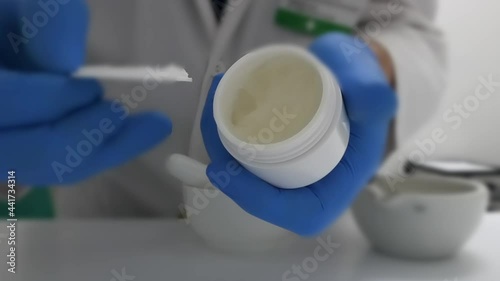 Opening an ointment jar in the prescription lab. Selective focus