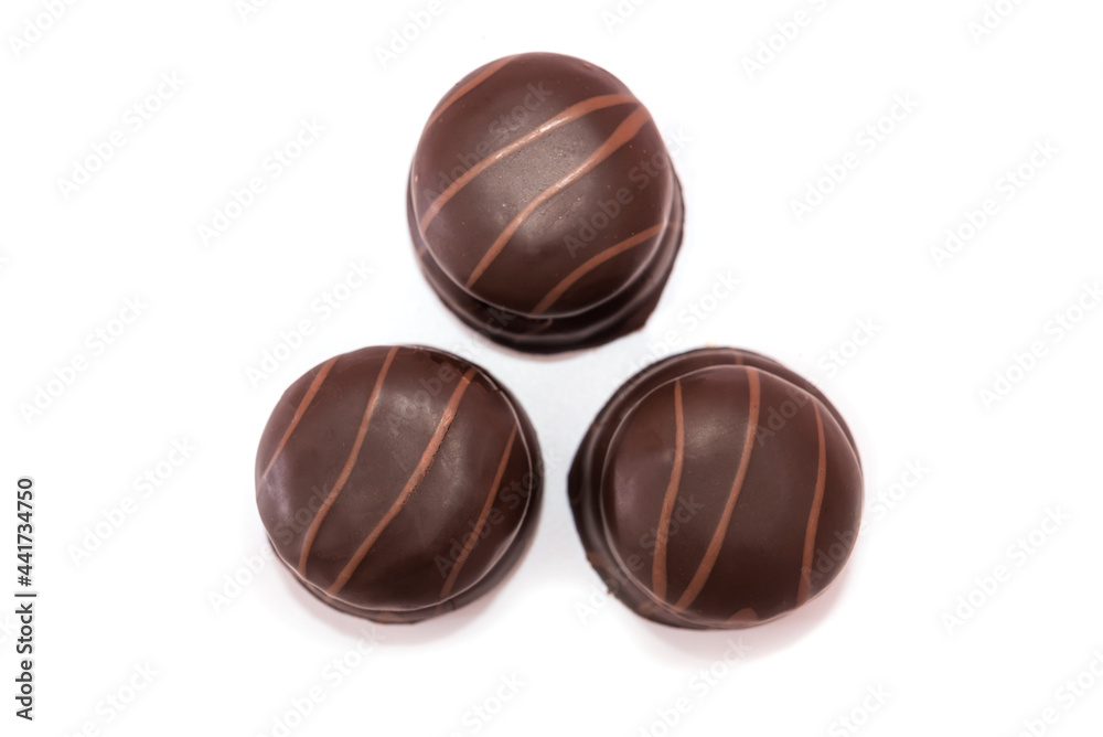 Fototapeta premium three chocolate candies isolated on white background.
