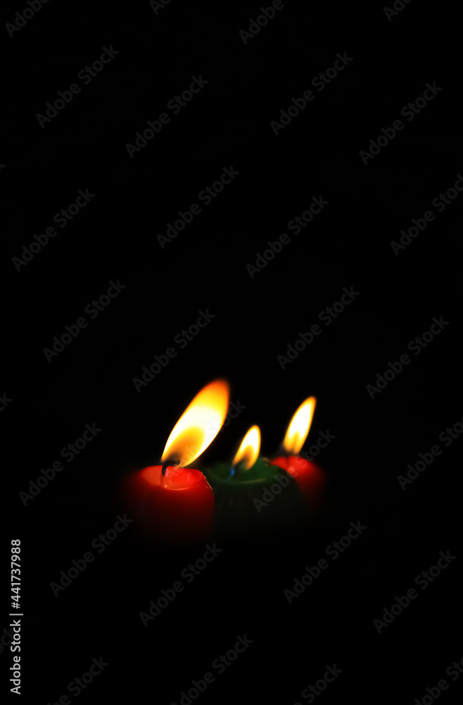 Burning candle on black background, Candle in the dark, Design for the background and wallpaper. copy space. Burning candle on black background, Candle in the dark, Design for the background and wallpaper. copy space.