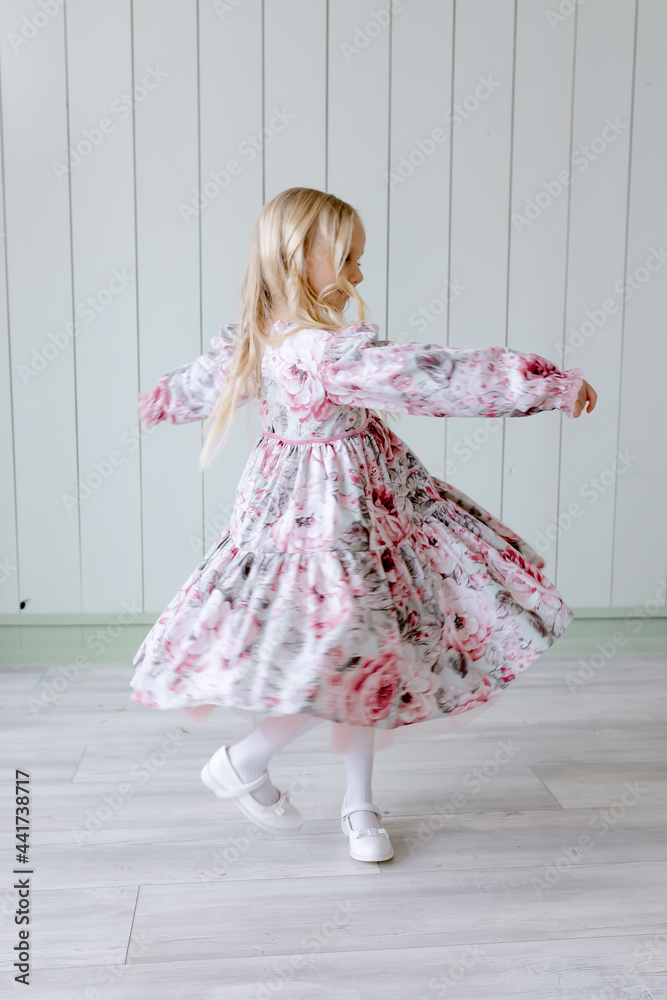 Child girl in a dress is dancing Graceful outfit for the holiday