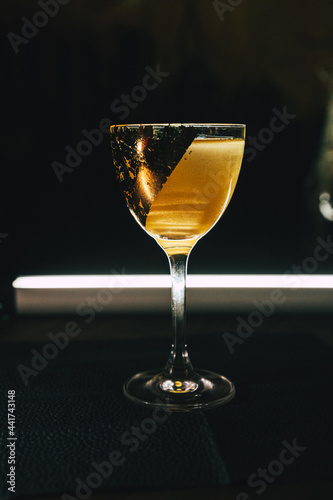 Golden cocktail in a decorated glass Alcohol luxury aesthetics