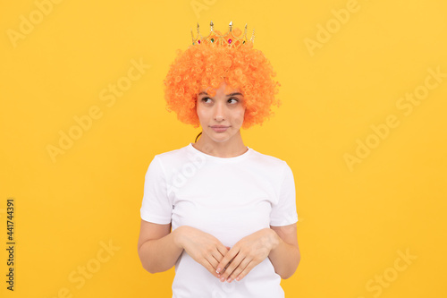 i am a queen. cheerful freaky girl. fancy party look. egocentric woman in clown wig and crown.