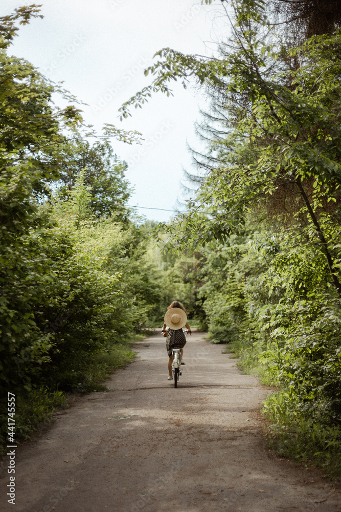 young girl riding a bicycle in the woods
