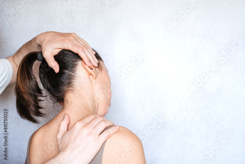 Massage therapist performing a manipulation on woman's neck and administering of spinal adjustments to relive neck pain