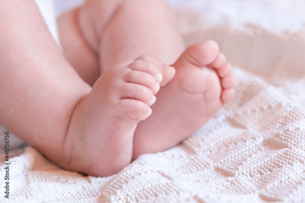 Tiny Babies Feet on White Blanket. Close up of Small Bare Feet of Baby Infant Sleeping on Soft Bed. Cute Newborn Baby Against Knitted Blanket. Childhood. Sleeping Newborn Child Tiny Babies Feet on White Blanket. Close up of Small Bare Feet of Baby Infant Sleeping on Soft Bed. Cute Newborn Baby Against Knitted Blanket. Childhood. Sleeping Newborn Child